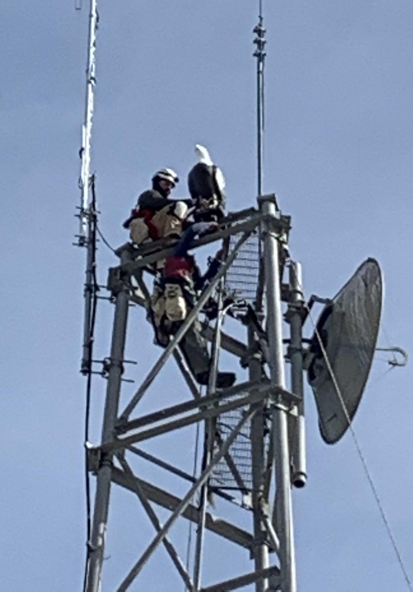 Installer mounting an eagle effigy on a tower